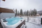 The private hot tub overlooks the ski resort.